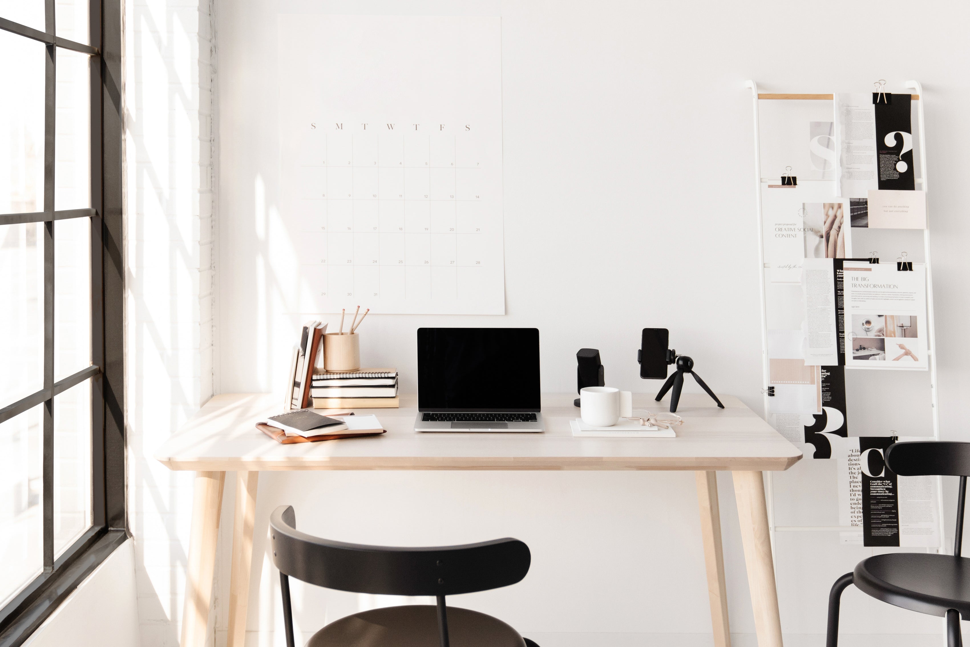 Laptop and camera setup on desk in very bright room